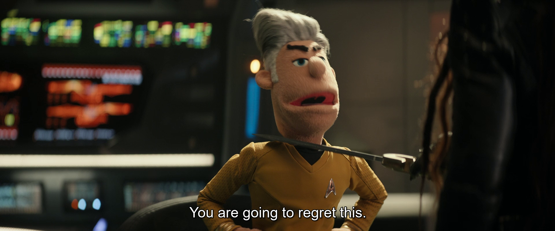 A puppet character dressed as a Star Trek officer is speaking with a stern expression, saying, You are going to regret this.