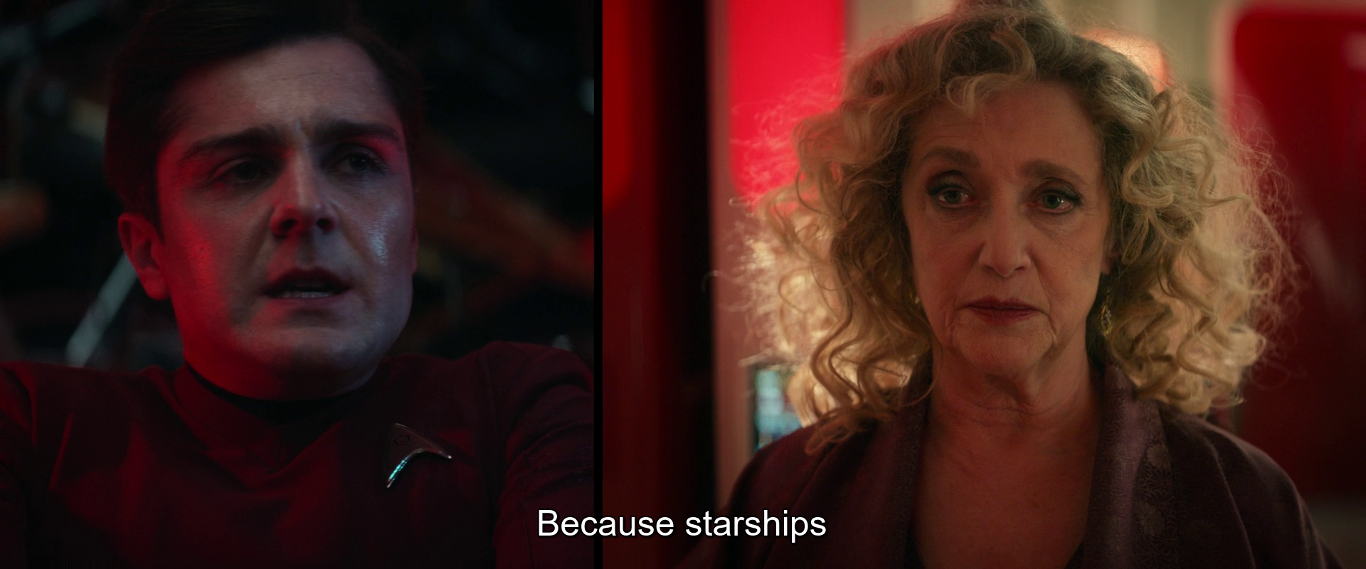 A man in a red uniform looks concerned while a woman with curly hair calmly explains, saying, Because starships.